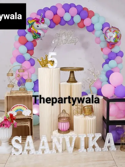 A magical unicorn theme with a pastel purple, pink, and aqua balloon arch. The unicorn foil balloons and light-up number "5" make this a dream come true for any unicorn lover.