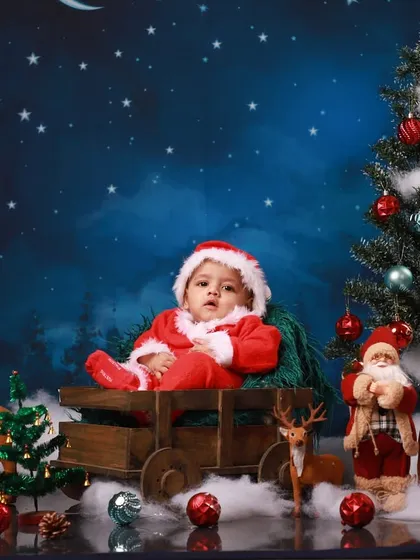 The full view of the magical Christmas sleigh setup. The starry night backdrop, decorated tree, and reindeer figures all come together to create a complete and immersive festive scene for your baby's portrait.