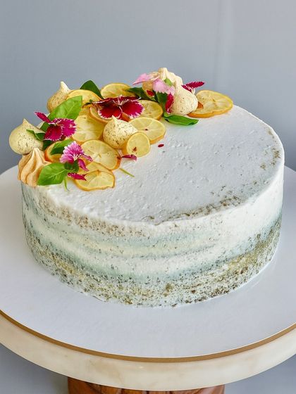 Zesty, herby, and unapologetically unique. My Lemon Basil Naked Cake is made with a light lemon basil sponge, balanced with lemon curd, and topped with candied lemons and fresh basil leaves for an adventurous dessert.
