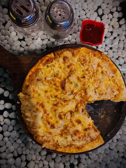 My Alfredo Pizza is pure cheesy goodness on a thin crust. It arrives at your table hot and bubbling, but it never lasts long once everyone grabs a slice.