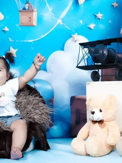 A moment of pure excitement from this six-month-old baby girl, with her arms raised in the air.