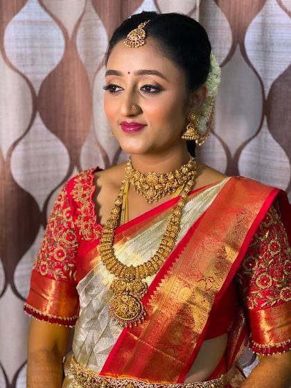 A three-quarter profile of Vidya, highlighting the clean lines of her hairstyle and the way the makeup enhances her features for a picture-perfect finish.