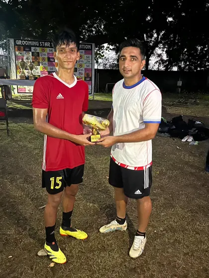 Our player receiving the MVP award for his outstanding performance.