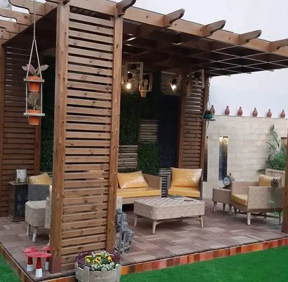 I designed this outdoor living area to be a true extension of the home. The custom wooden pergola provides structure and shade, while the integrated seating and layered lighting create a warm, inviting atmosphere for relaxing or entertaining, day or night.