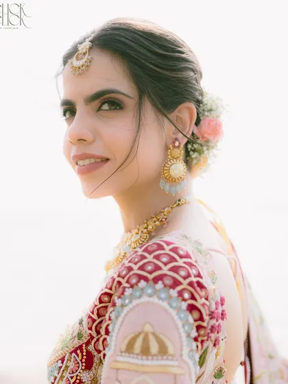 A beautiful close-up of the bride, Ashna. Her serene expression, combined with the delicate floral hair accessories and the soft Goan light, makes for a timeless and elegant bridal portrait.