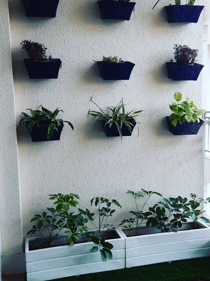 A closer look at the vertical garden solution. Wall-mounted planters are a great way to add life to a small balcony wall.