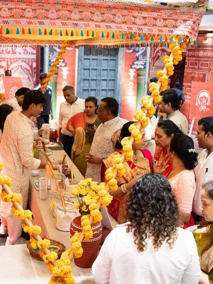 Guests gathered around a food counter, interacting with our staff and each other. Our interactive stations are designed to be social hubs, creating a dynamic and engaging atmosphere.