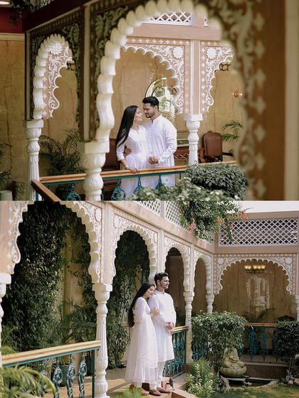 A pre-wedding shoot at a heritage location, with the couple dressed in matching white outfits. The classic architecture and serene expressions create a timeless and elegant portrait.