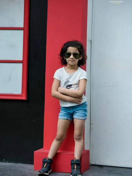 Who says photoshoots are just for babies? We love capturing the cool confidence and unique personality of older kids too, like this stylish pose against a colorful wall.