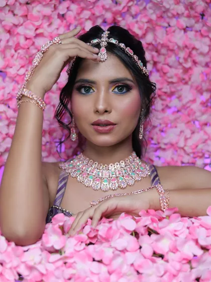 A stunning shot of the model surrounded by pink flowers, creating a dreamy and artistic visual.