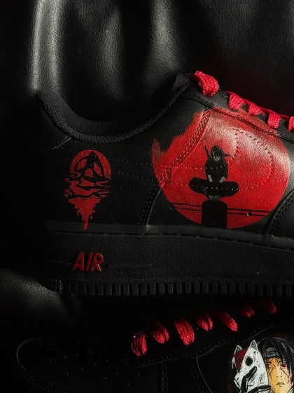 A close-up of the Itachi custom sneaker, showing the Akatsuki cloud symbol.