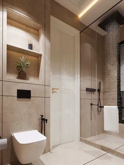 A view of the shower and toilet area, showing the cohesive use of beige tiles and matte black fixtures for a modern, understated look.