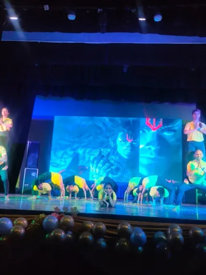 This warrior-like acro yoga pose was a powerful moment in our students' Holi performance. It demonstrates the strength and focus they have developed through their practice.