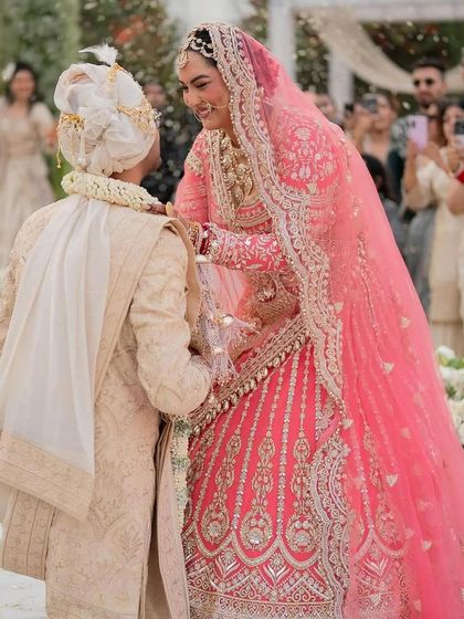 The beautiful bride during her Anand Karaj ceremony, surrounded by an abundance of fresh flowers. The joy on her face says it all.
