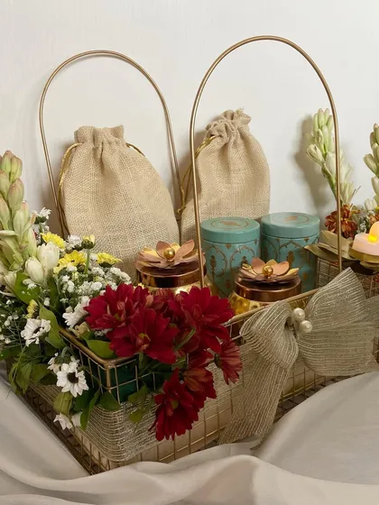 A closer view of the Diwali Treats basket, highlighting the beautiful contrast of the fresh flowers against the golden metal basket.