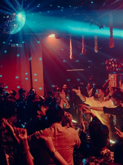 The dancefloor under the disco ball. A classic club scene where everyone is lost in the music.