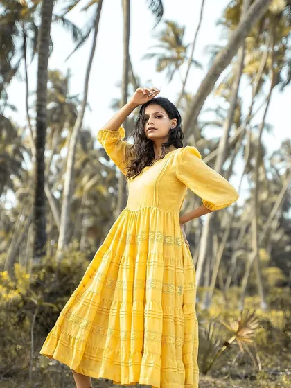 An outdoor fashion shoot where the hair is styled in natural, wind-swept waves. This look is all about creating a sense of effortless movement and connection with the natural surroundings.
