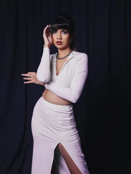 A mid-body shot that shows off the full outfit. The pose is confident and fashionable.