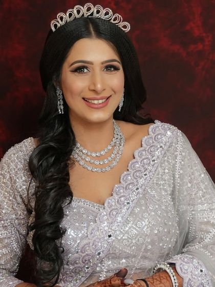 A smiling portrait of our engagement bride. She is wearing a beautiful tiara and a silver-grey gown, looking like a modern princess.