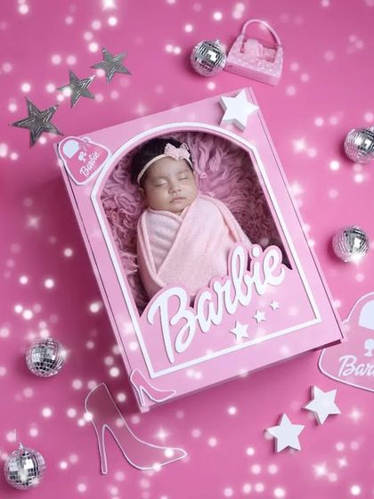 Pretty in pink. This newborn looks serene in her Barbie box, a creative concept that results in truly unique and eye-catching baby portraits.