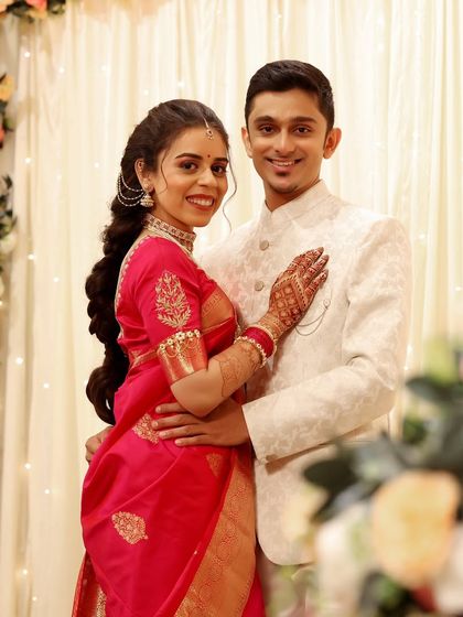 A classic engagement portrait. The couple looks happy and in love, and the bride's makeup is soft and romantic to match the moment.