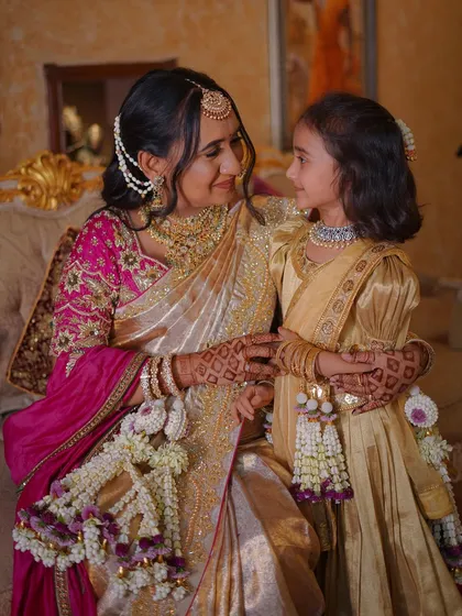 A sweet, candid moment between a mother and her daughter, both looking lovely in their matching outfits and our florals.