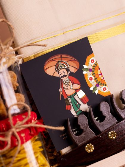 A close-up on the custom-designed Mahabali greeting card included in the 'Onasanchari' hamper. The intricate illustration adds a layer of artistry and cultural richness to the gift.