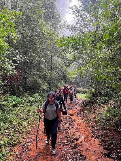 Our group navigating a muddy forest trail during the Kurinjal trek.