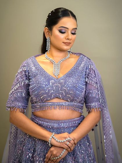 A modern lavender lehenga with intricate silver beadwork and a stylish blouse design. This rental is perfect for a sangeet or cocktail party.