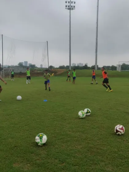 A snapshot from a training day, with footballs scattered across the pitch, ready for the next drill.
