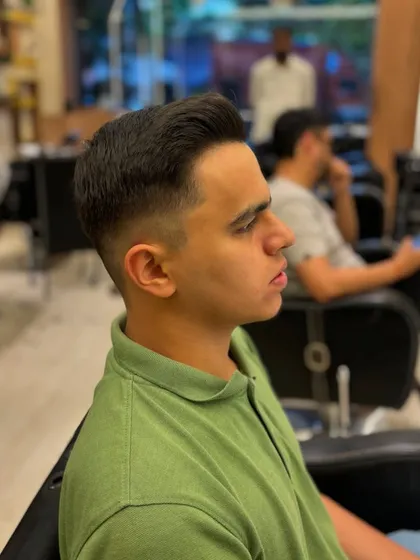 A three-quarter view of a men's haircut, showcasing the sleek styling and expert fading.