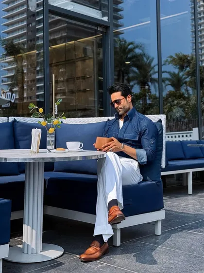 Our custom indigo denim shirt styled for a business brunch. Paired with white pleated trousers, it strikes the perfect balance between relaxed and refined.