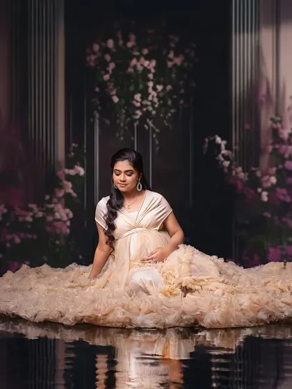 A serene and magical edit, placing the mom-to-be in a surreal, reflective water palace. This is for clients who want a portrait that is truly out of this world.