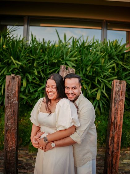 A happy, candid hug captured at a beautiful resort in the Rishikesh area, showing a moment of pure joy.