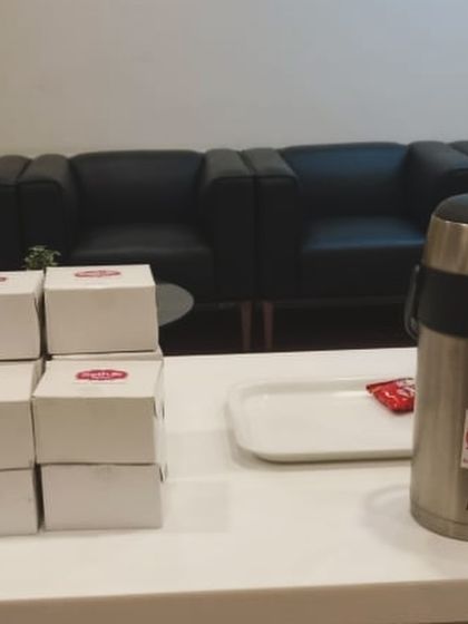 A setup for a corporate tea break, featuring our snack boxes and a large flask of hot chai. It's a simple and effective way to cater for meetings and small events.