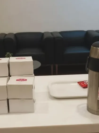 A setup for a corporate tea break, featuring our snack boxes and a large flask of hot chai. It's a simple and effective way to cater for meetings and small events.