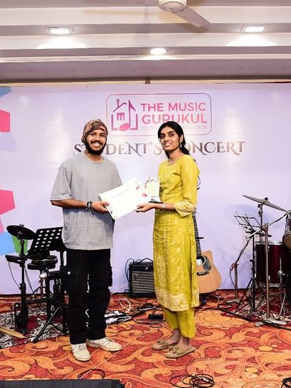 A student receives her certificate on stage. These moments of recognition are a huge motivation for our learners.