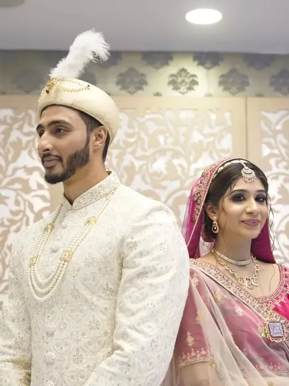 A regal portrait of a Muslim couple on their wedding day, showcasing their elegant traditional attire.