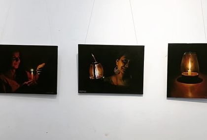 A clear shot of the three candle-light paintings.