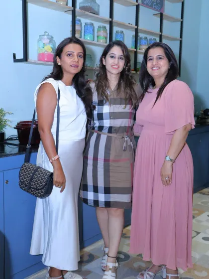 A trio of friends looking chic and happy at a party in our cafe area.