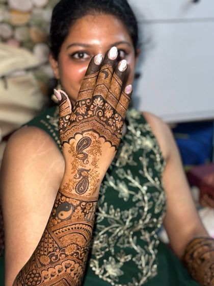 This bridal design is inspired by the beauty of Indian architecture, with jharokha-style windows and peacock motifs.