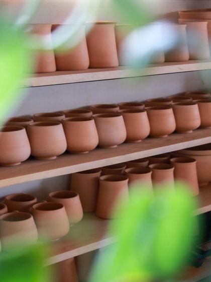 Shelves filled with bisque fired pottery, waiting to be glazed. A satisfying sight that represents hours of hard work and creative potential.