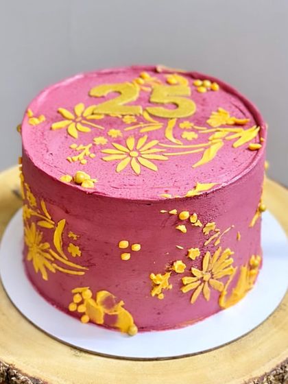 This cake was custom-designed to match the birthday girl's outfit. I used a vibrant pink buttercream and hand-piped yellow floral patterns to echo the design of her dress.
