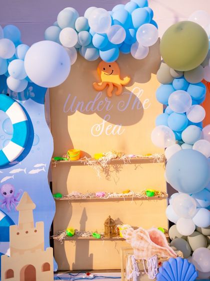 A close-up of the return gift display area, themed to look like a sandy ocean floor. The 'Under The Sea' sign and cute octopus detail tie everything together.