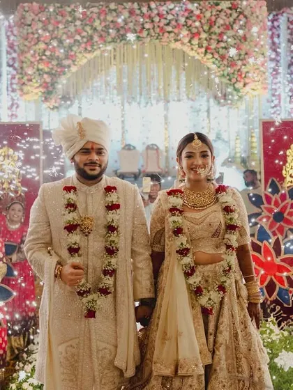 A beautiful couple portrait after their varmala, walking down the aisle together through a path of sparkling cold pyros. This is the start of their new journey.