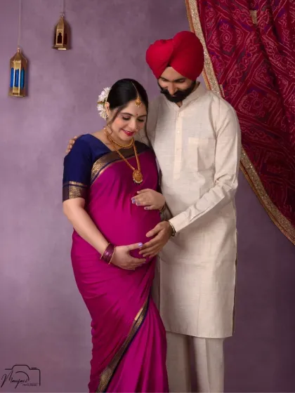 A beautiful portrait of a Sikh couple. The rich magenta saree and his traditional kurta create a vibrant and loving image.