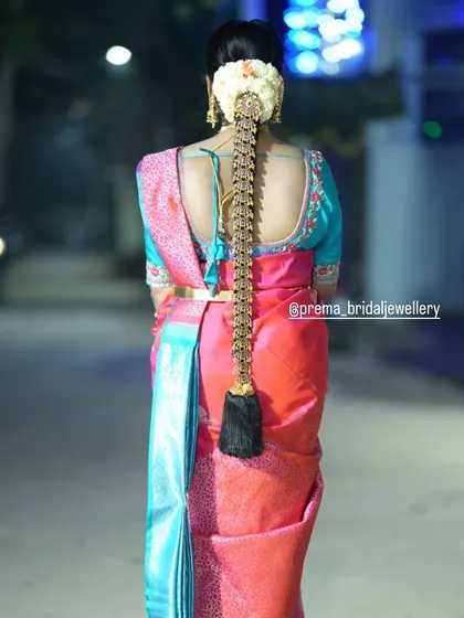 It's all in the details. A traditional South Indian bridal look is incomplete without an elaborate hairstyle. This long, decorated braid, known as a poola jada, is a classic choice that I love creating.