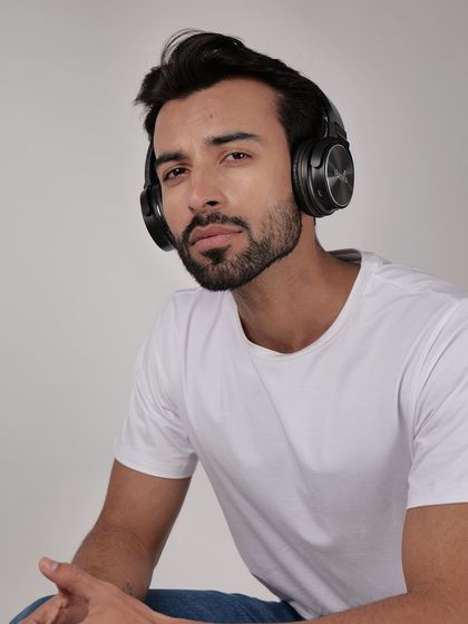 Another angle of a model wearing headphones. Providing multiple views with a model helps customers get a better sense of the product's design and fit.