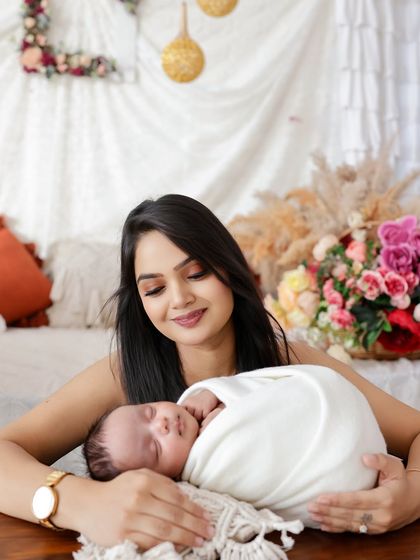 A mother's gentle gaze says it all. I focus on capturing these quiet, candid moments of connection during our family newborn sessions.