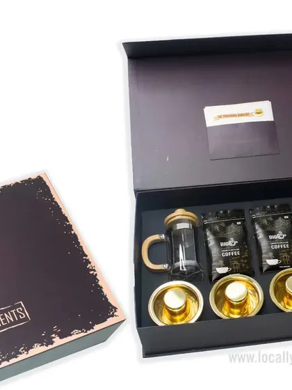 This premium coffee-themed gift box is perfect for any celebration. It includes a French press, coffee grounds, and elegant cups, all beautifully arranged in a "Best Compliments" box.